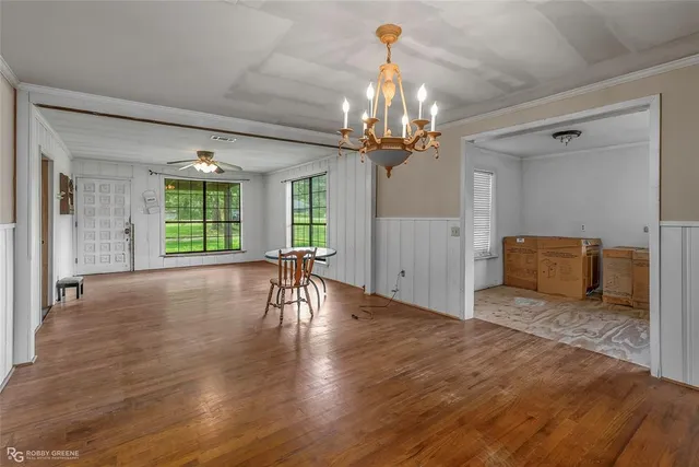 a view of a livingroom with a furniture wooden floor and chandelier