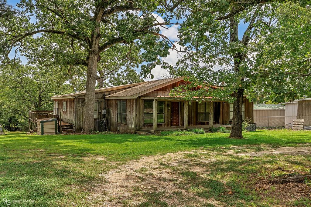411 Camp Bistno Road Doyline, LA 71023 - Photo 2 of 32 a front view of a house with a yard and trees
