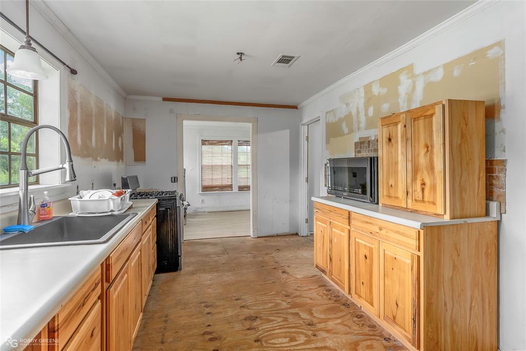 411 Camp Bistno Road Doyline, LA 71023 - Photo 22 of 32 a kitchen with stainless steel appliances granite countertop a refrigerator and a sink