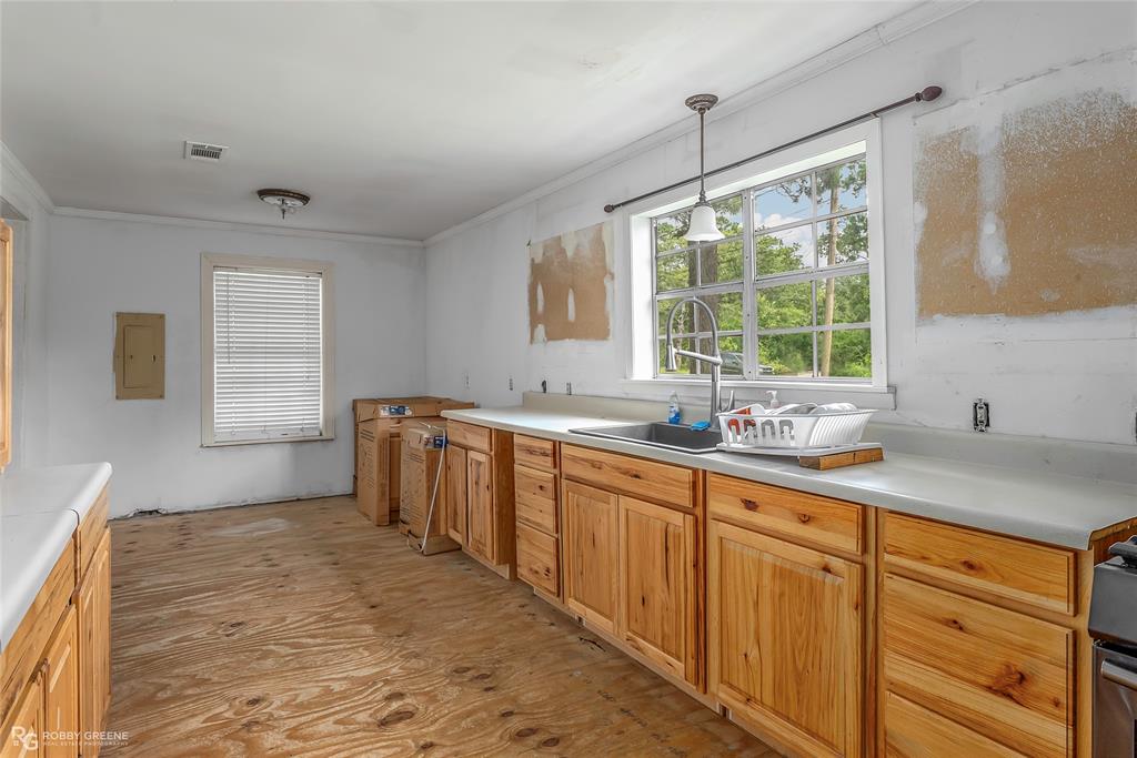 411 Camp Bistno Road Doyline, LA 71023 - Photo 23 of 32 a kitchen with sink refrigerator and window