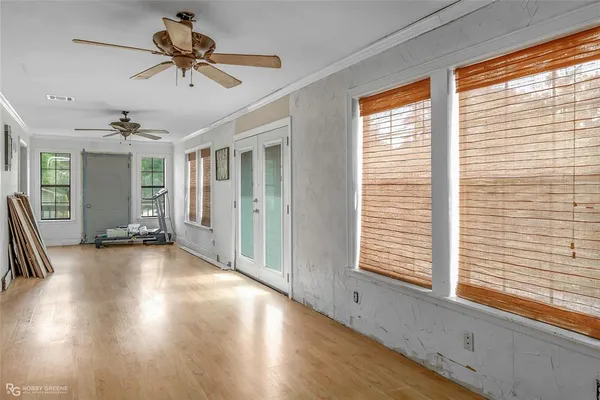 a view of a livingroom with a ceiling fan and window