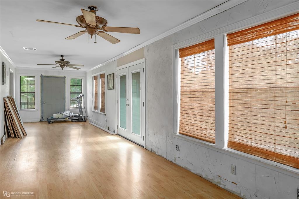 411 Camp Bistno Road Doyline, LA 71023 - Photo 28 of 32 a view of a livingroom with a ceiling fan and window