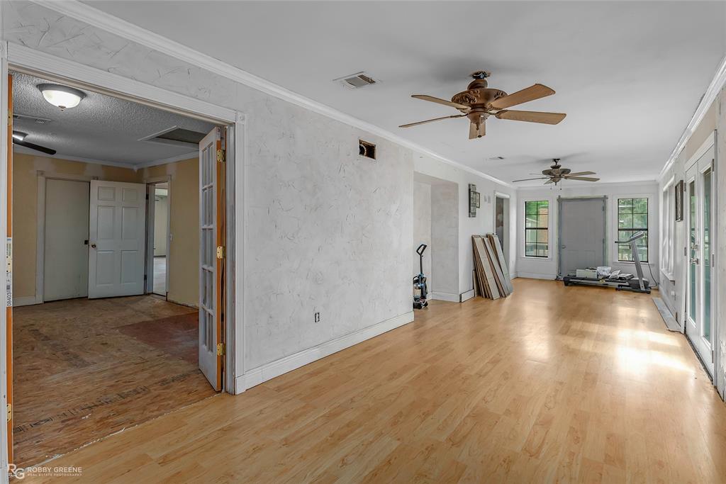 411 Camp Bistno Road Doyline, LA 71023 - Photo 29 of 32 a view of empty room with wooden floor and ceiling fan