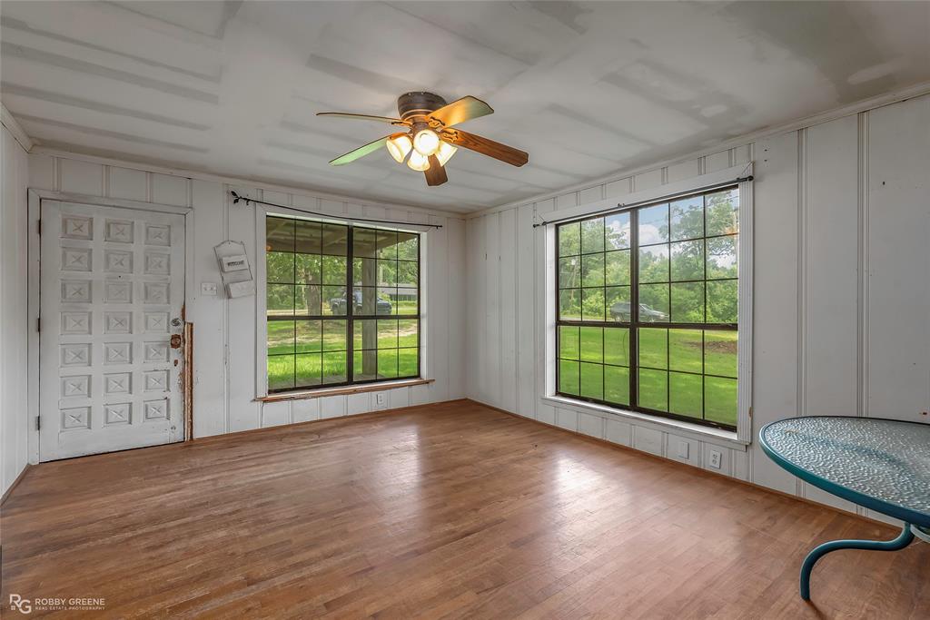 411 Camp Bistno Road Doyline, LA 71023 - Photo 10 of 32 a view of an empty room with wooden floor and a window