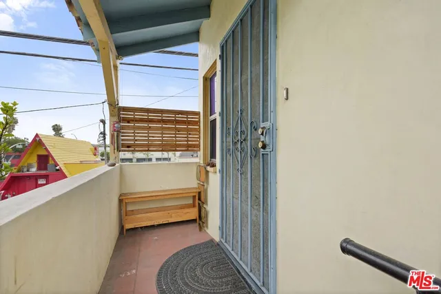 a view of a livingroom with furniture and a gym cycle