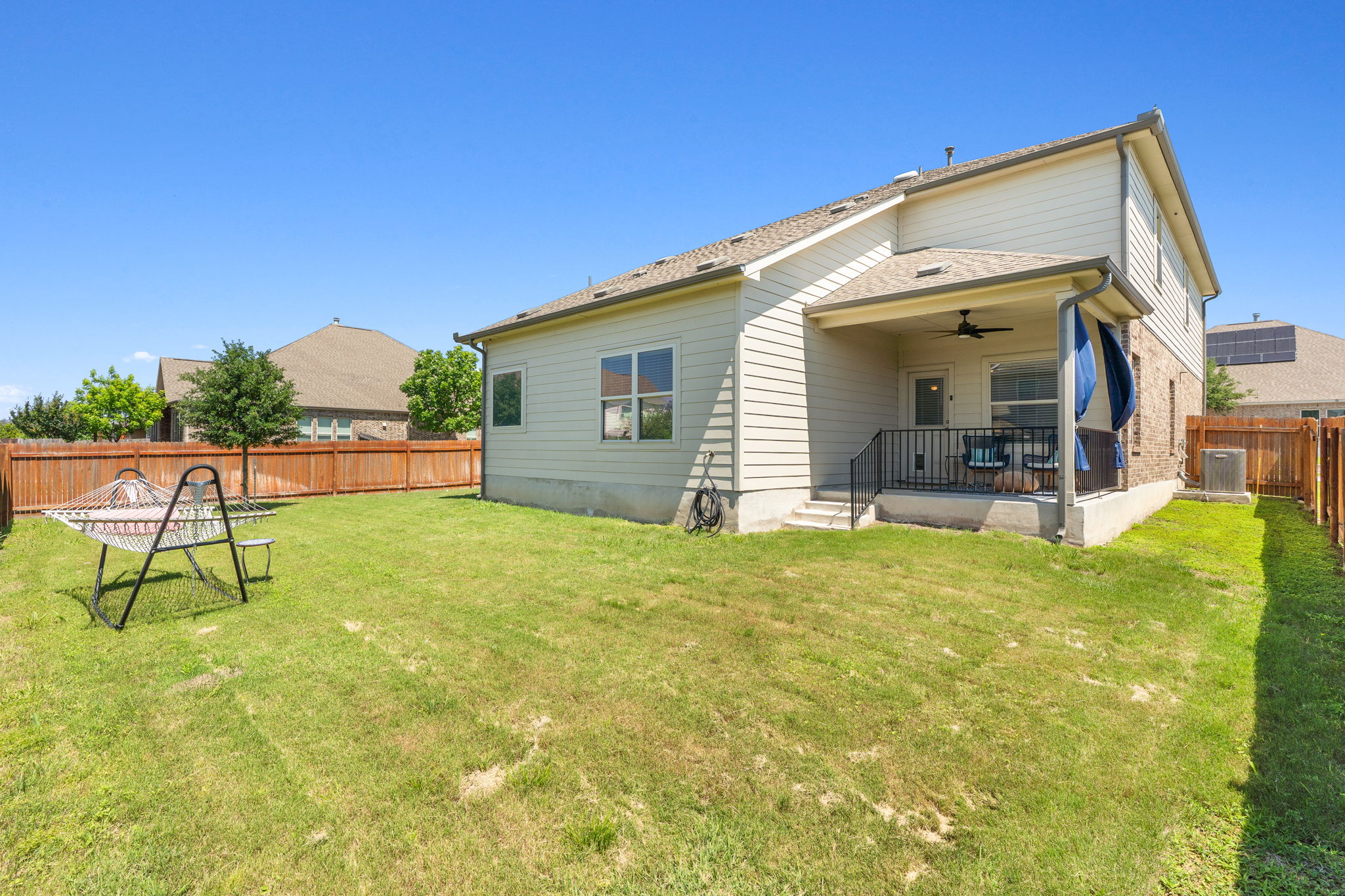 3101 Fresh Spring Road Pflugerville, TX 78660 - Photo 29 of 39 Expansive backyard featuring a covered patio, ceiling fan, and privacy fencing