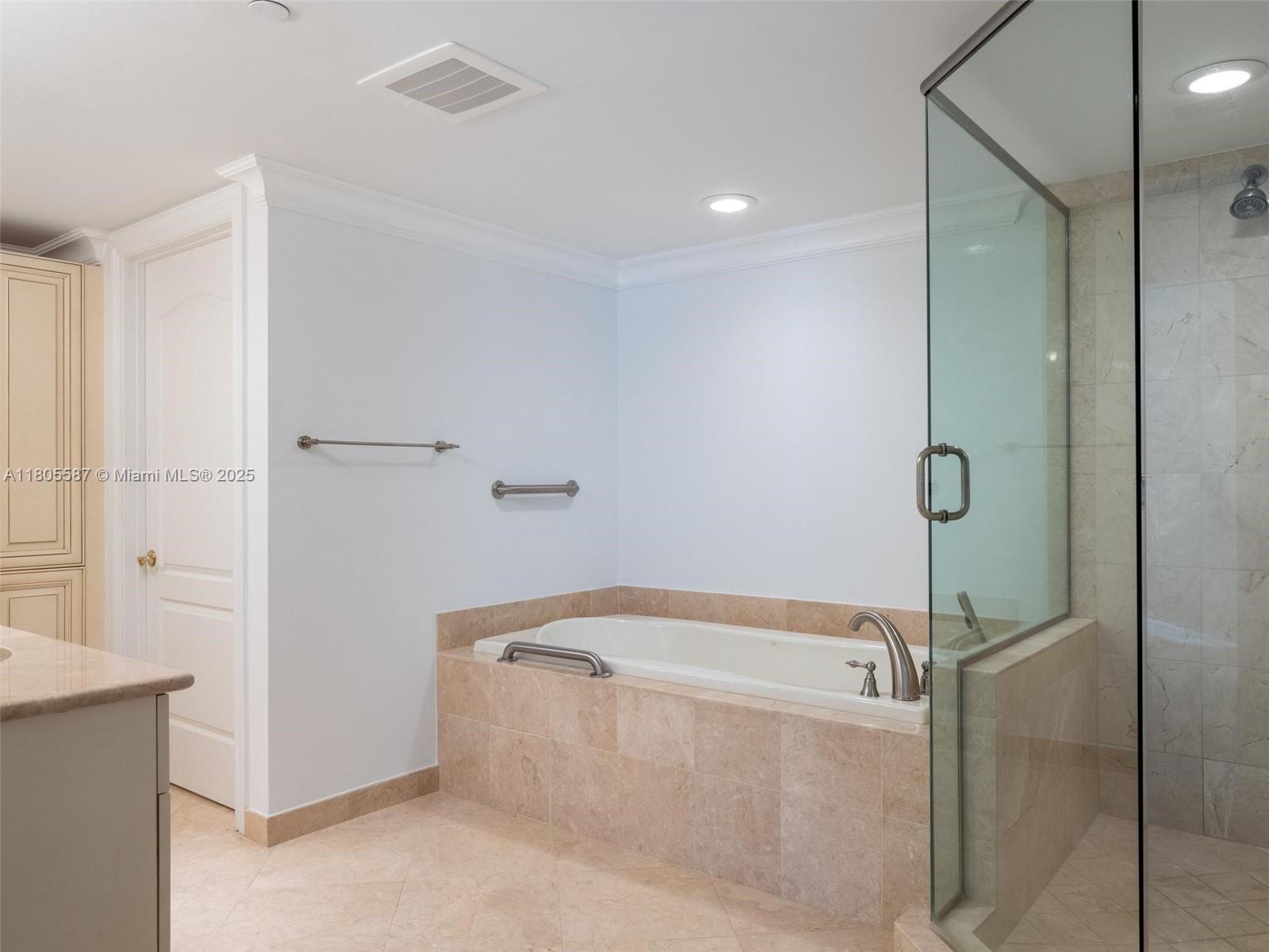 200 East Palmetto Park Road, Unit 700 Boca Raton, FL 33432 - Photo 19 of 36 a bathroom with a tub and shower