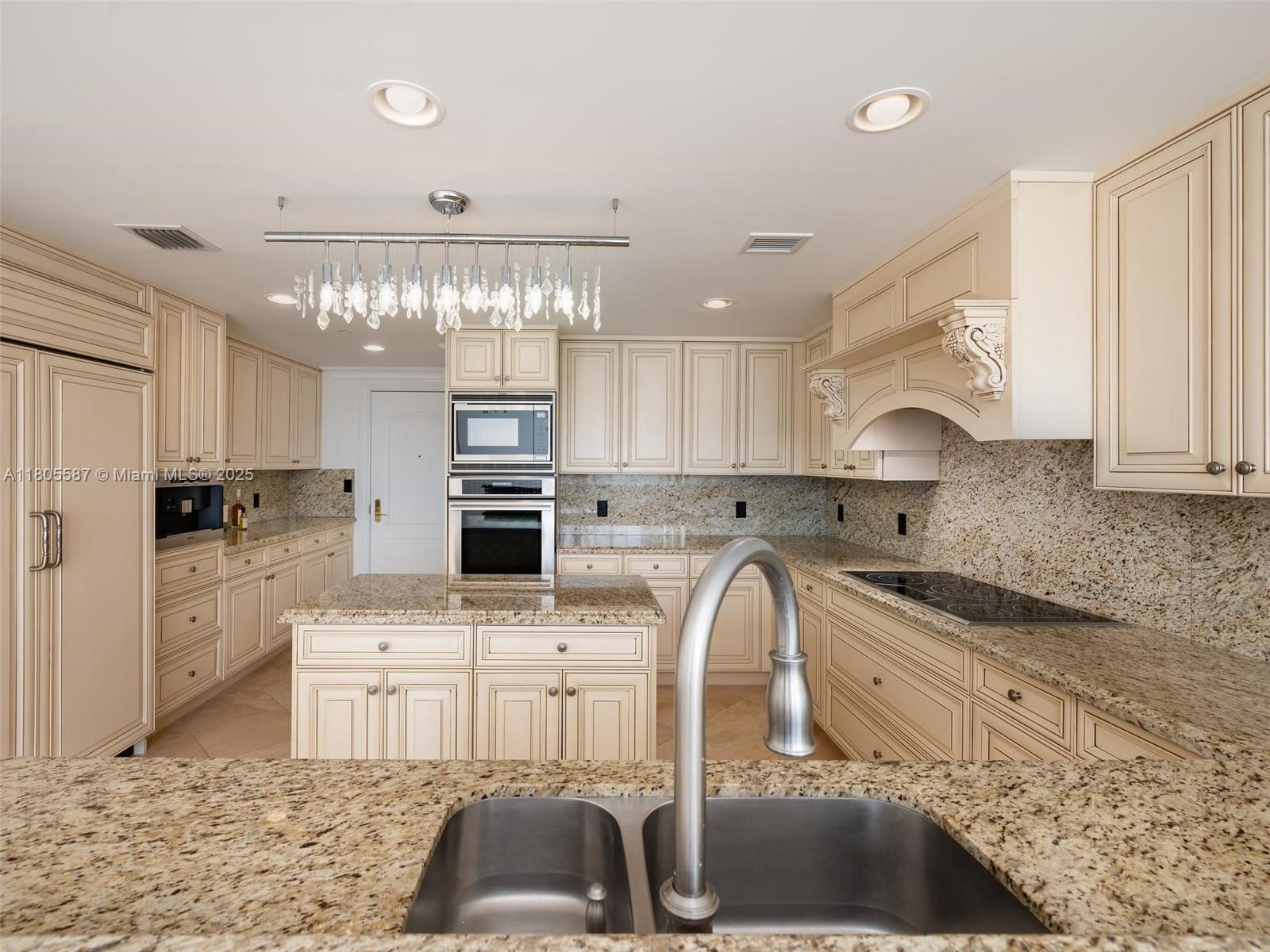 200 East Palmetto Park Road, Unit 700 Boca Raton, FL 33432 - Photo 6 of 36 a kitchen with stainless steel appliances granite countertop a sink stove and refrigerator