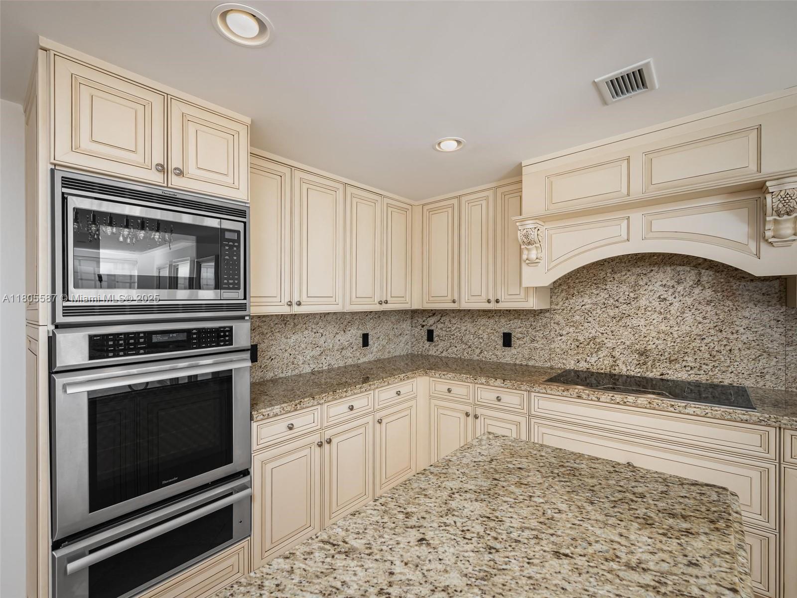 200 East Palmetto Park Road, Unit 700 Boca Raton, FL 33432 - Photo 9 of 36 a kitchen with granite countertop cabinets stainless steel appliances and a counter space