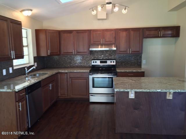 3853 Bess Road Jacksonville, FL 32277 - Photo 3 of 22 a kitchen with stainless steel appliances granite countertop a stove a sink dishwasher and a microwave oven on the wooden floor