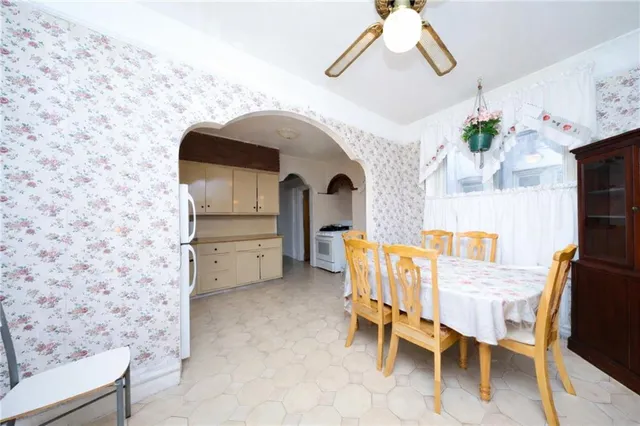 a kitchen with a refrigerator and white cabinets