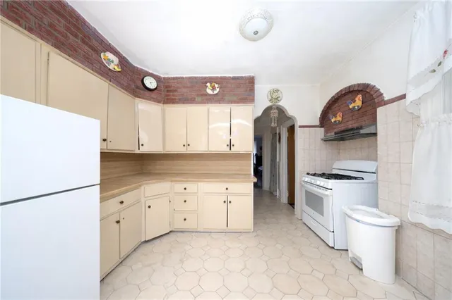 a bedroom with a bed and a chair