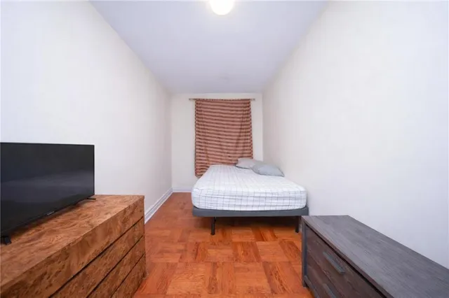 a bedroom with a bed and a window in it