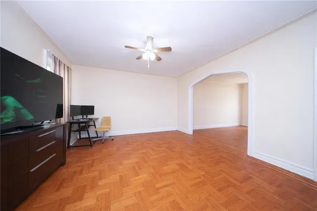 a view of a livingroom with furniture and a ceiling fan