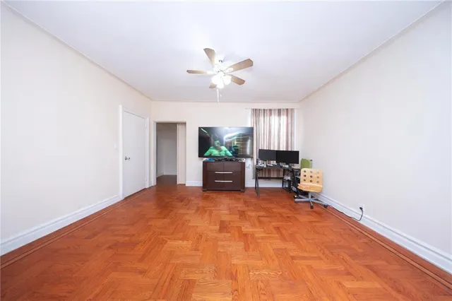 a bedroom with furniture and a flat screen tv