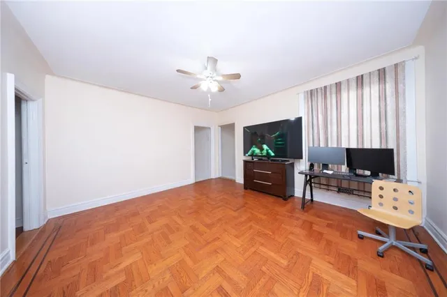 a view of a dining room with furniture and a chandelier fan