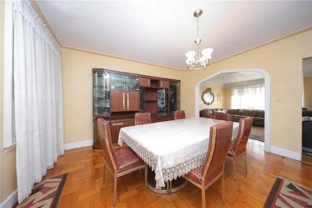 a spacious bedroom with a bed and a chandelier