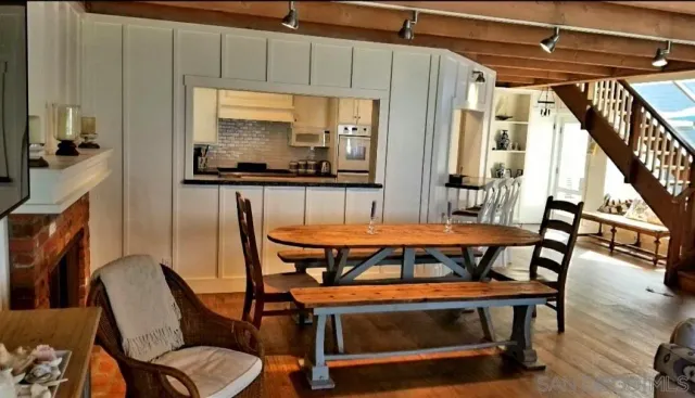 a kitchen with stainless steel appliances a refrigerator a stove and white cabinets