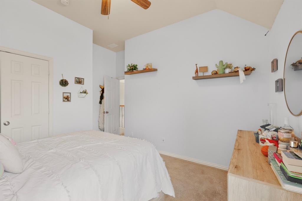 4004 White Porch Road Plano, TX 75024 - Photo 28 of 40 a bedroom with a bed and a couch