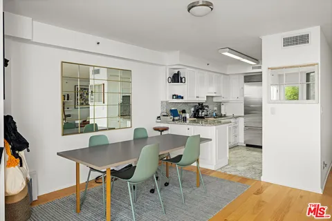 a living room with furniture and a book shelf