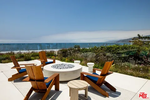 a view of a living room with furniture and floor to ceiling window