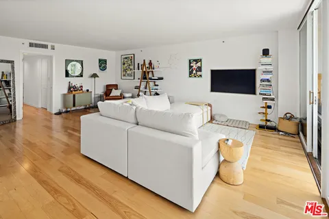 a bedroom with a bed and a view of balcony