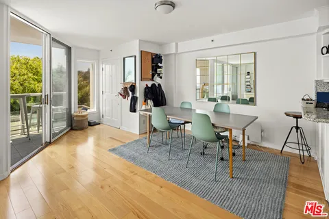 a kitchen with stainless steel appliances granite countertop a refrigerator a sink and white cabinets