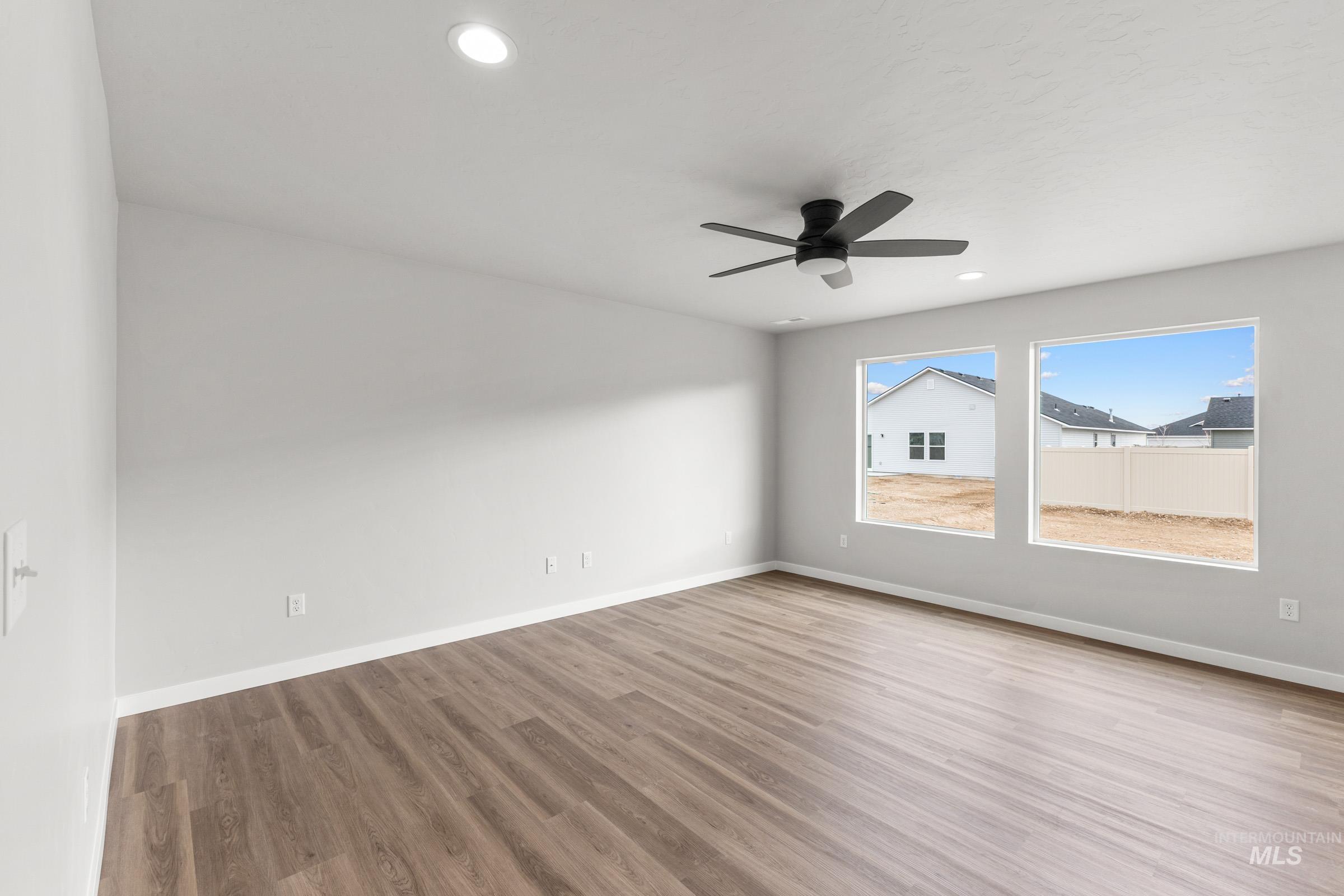 461 Waverly Avenue Middleton, ID 83644 - Photo 7 of 22 Spare room featuring wood finished floors, ceiling fan, and recessed lighting