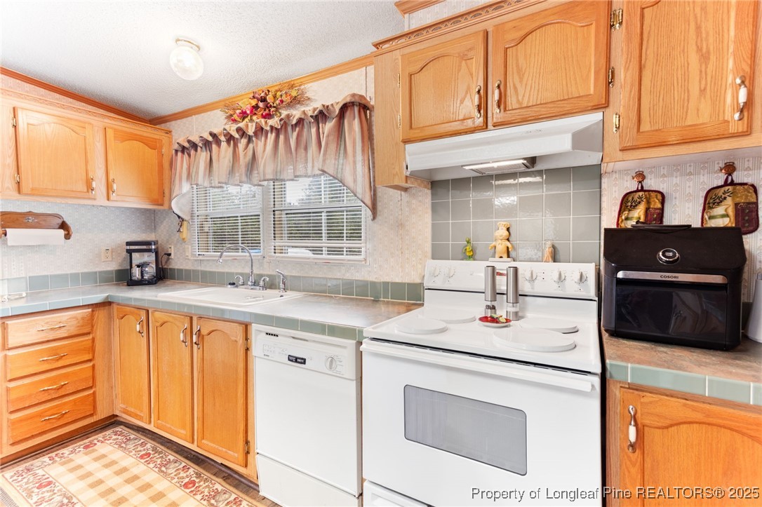 520 Inverary Drive Raeford, NC 28376 - Photo 16 of 43 a kitchen with stainless steel appliances granite countertop a sink stove and cabinets
