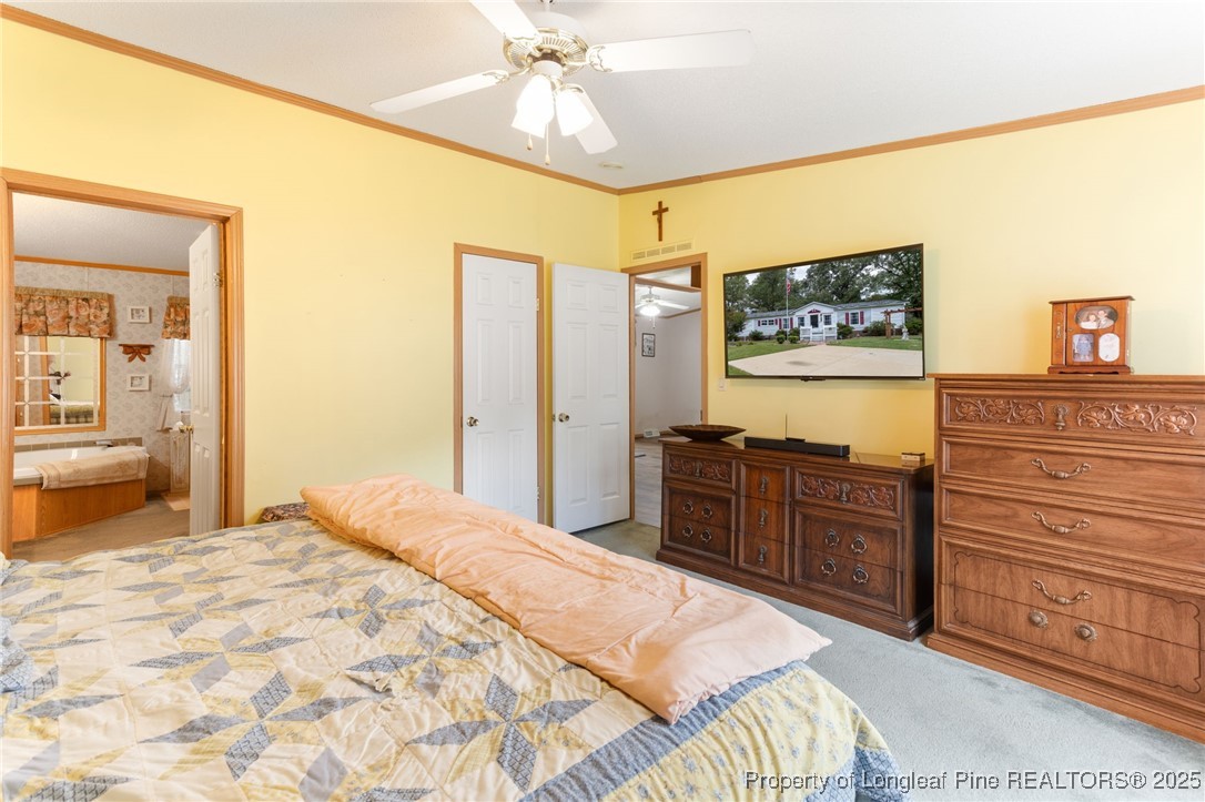 520 Inverary Drive Raeford, NC 28376 - Photo 18 of 43 a bedroom with a bed and a flat screen tv