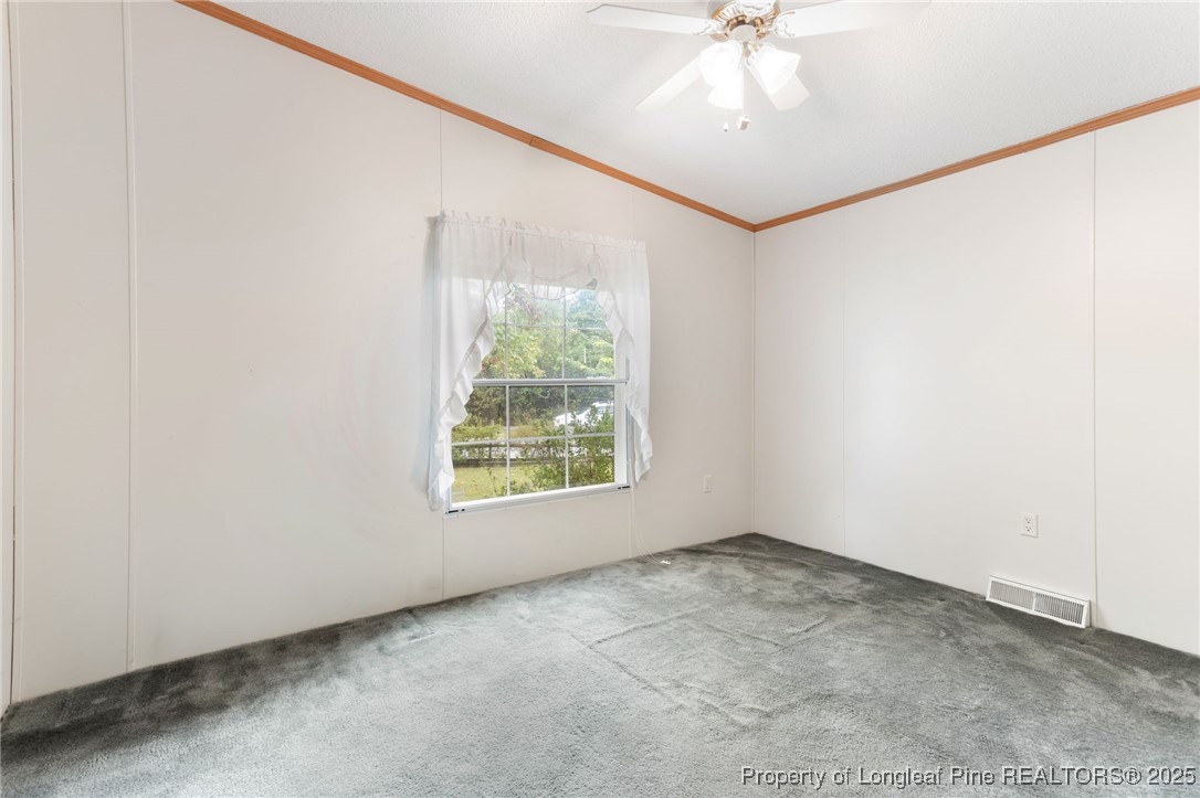 520 Inverary Drive Raeford, NC 28376 - Photo 23 of 43 an empty room with a window and a ceiling fan