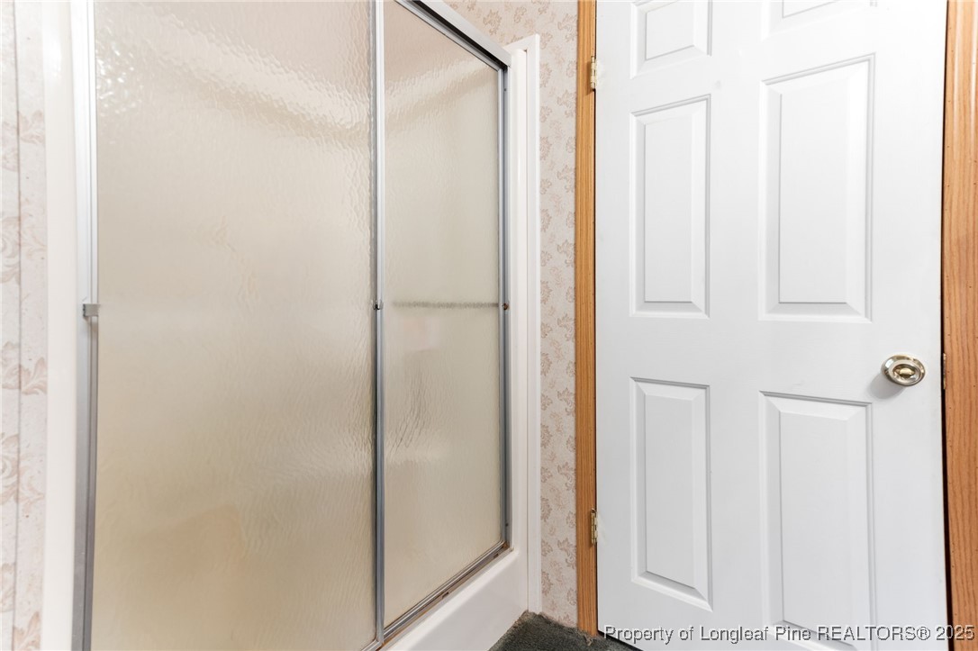 520 Inverary Drive Raeford, NC 28376 - Photo 28 of 43 a bathroom with a glass shower door