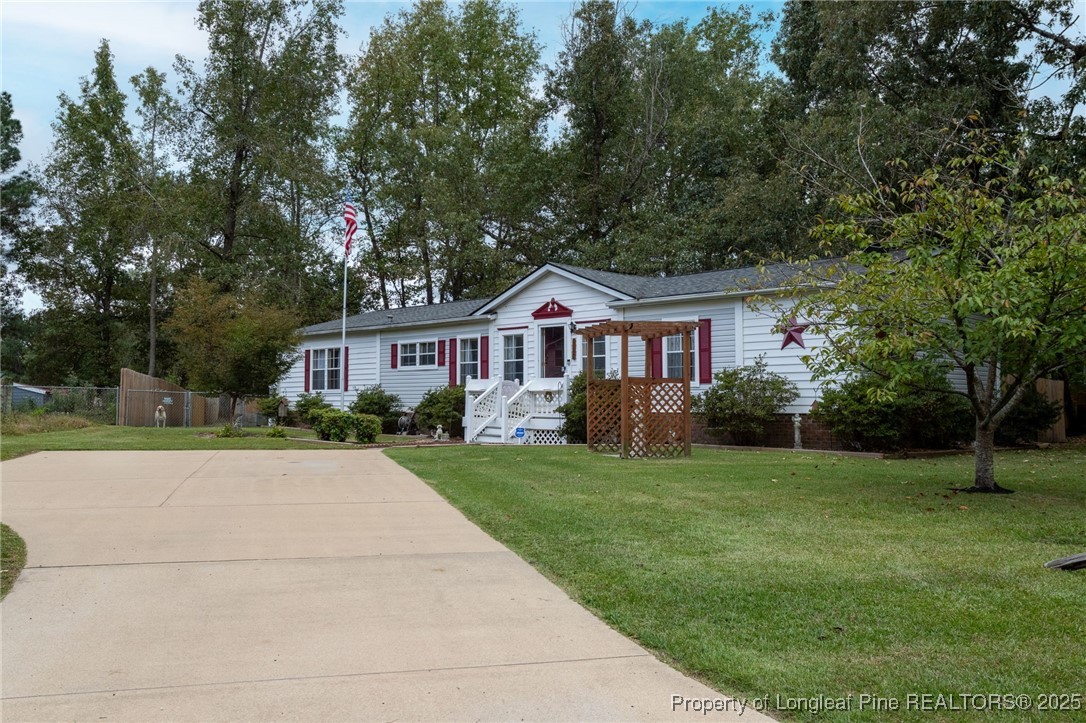 520 Inverary Drive Raeford, NC 28376 - Photo 3 of 43 a front view of a house with a yard and trees