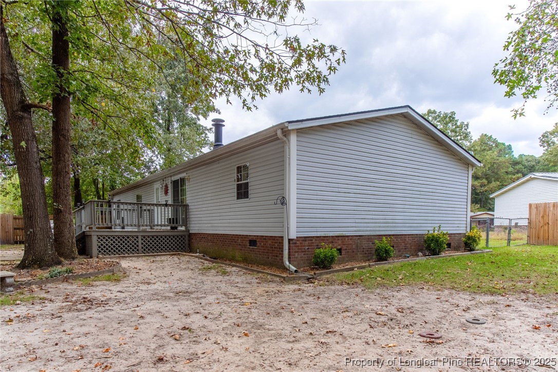 520 Inverary Drive Raeford, NC 28376 - Photo 35 of 43 a backyard of a house with wooden fence and large trees