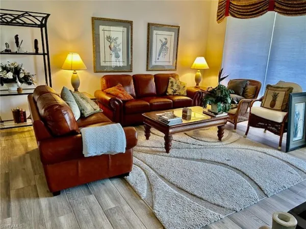 a living room with furniture and lamp