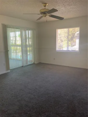 an empty room with closet and windows