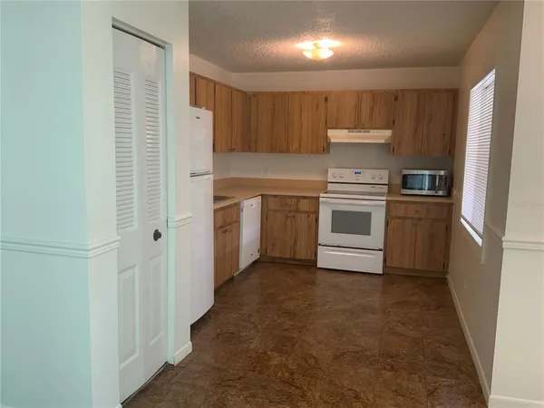a utility room with cabinets washer and dryer
