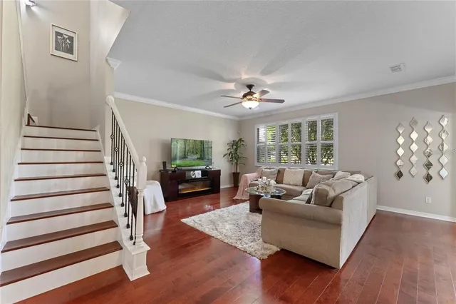 a living room with furniture and wooden floor