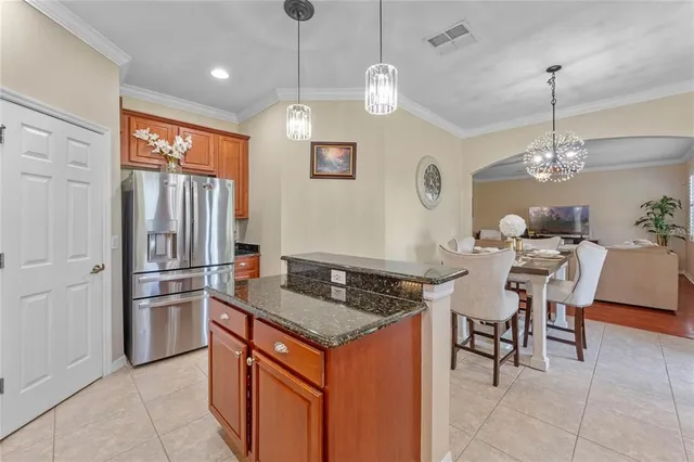 a kitchen with stainless steel appliances granite countertop a refrigerator a stove a sink and a microwave