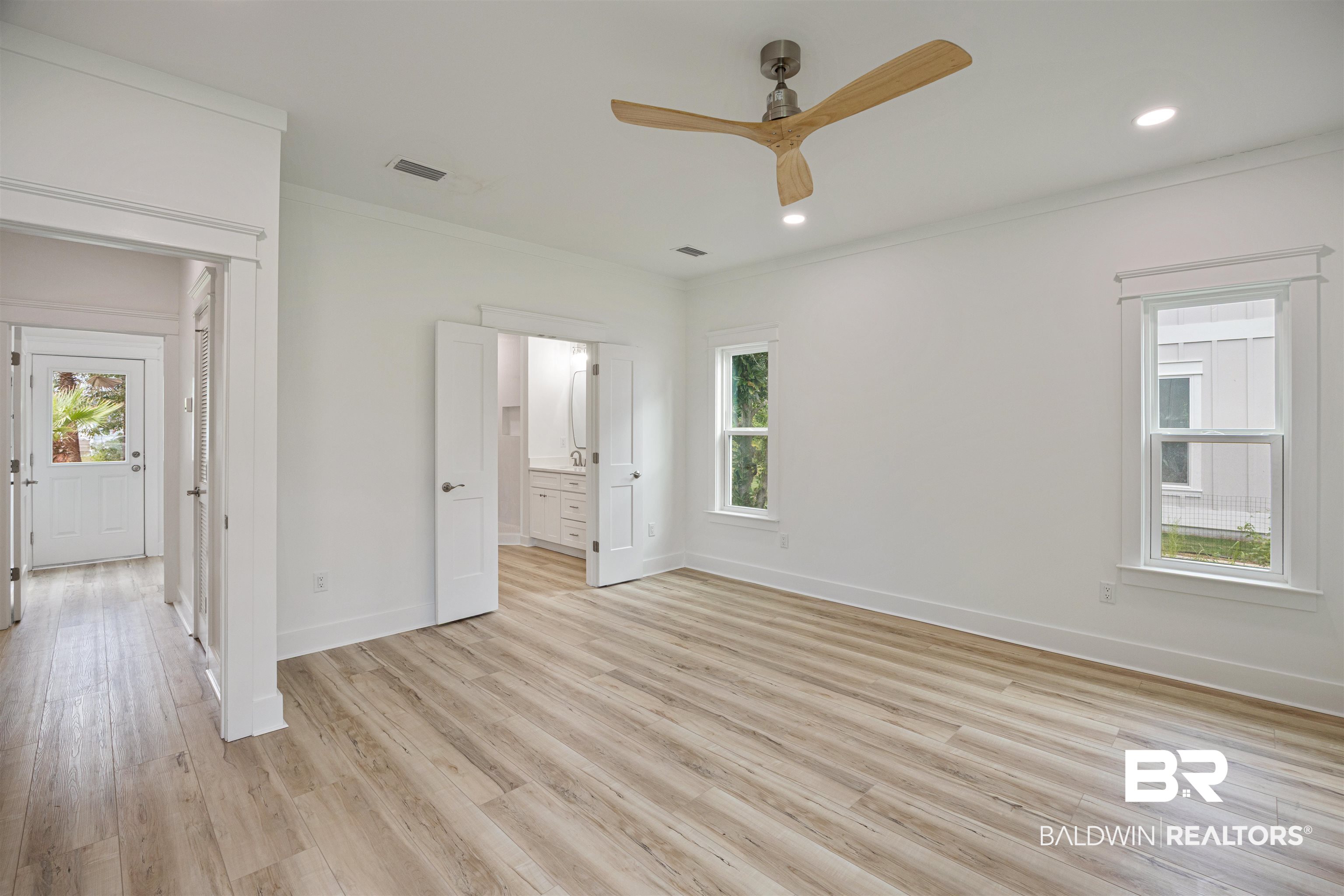 27591 Canal Road Orange Beach, AL 36561 - Photo 19 of 51 Unfurnished bedroom with ornamental molding, light wood finished floors, recessed lighting, ceiling fan, and connected bathroom