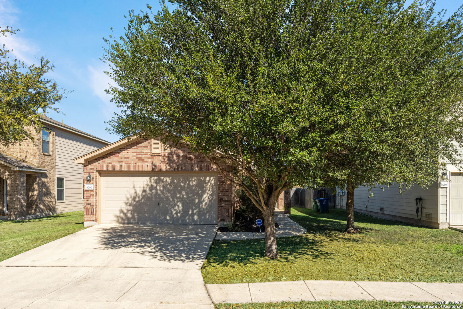 a backyard of a house with garden and barbeque oven