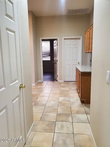 a view of a livingroom with wooden floor kitchen and window