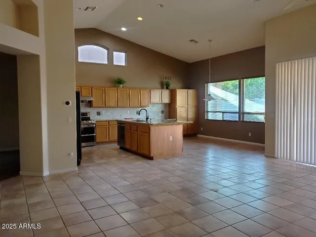 a kitchen with stainless steel appliances a refrigerator and a stove top oven