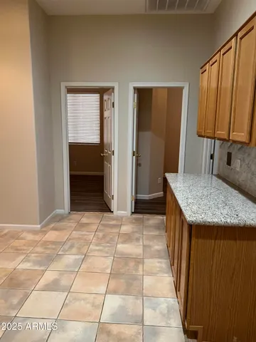 a kitchen with granite countertop a sink and a cabinets