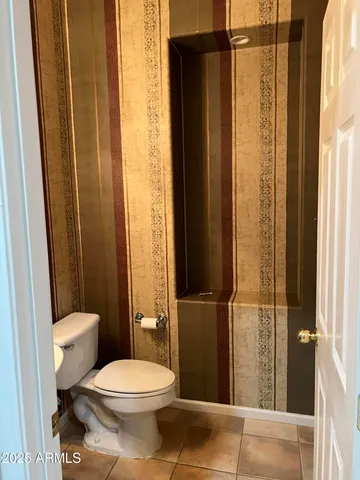 a bathroom with a toilet and shower