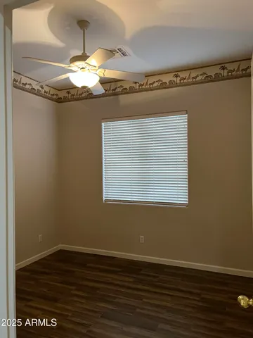 a view of a chandelier fan wooden floor and staircase