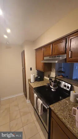 a kitchen with a sink a stove and cabinets