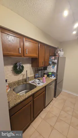a kitchen with a sink a stove and cabinets