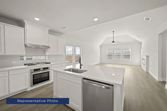a kitchen that has a sink and a stove in it