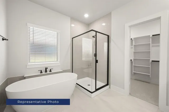 a bathroom with a bathtub and a shower